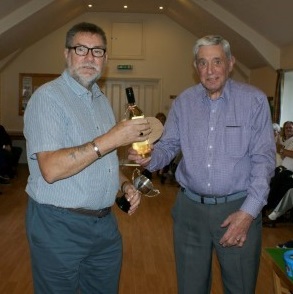 Lionel presented with the winners trophy and prize